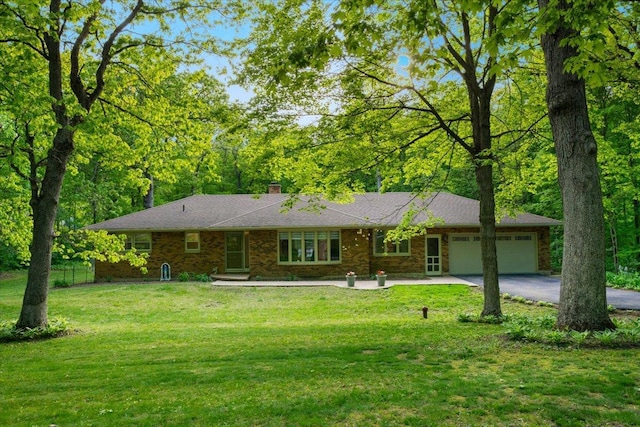 7417 N Hill Rd, Marengo, IL 60152 - single story home with a garage, asphalt driveway, a chimney, and brick siding