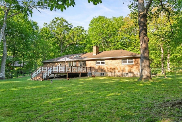 7417 N Hill Rd, Marengo, IL 60152 - rear view of property featuring a wooden deck, a chimney, and a lawn
