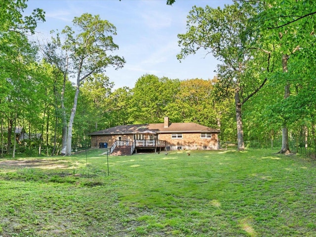 7417 N Hill Rd, Marengo, IL 60152 - view of grassy yard with a deck and a view of trees