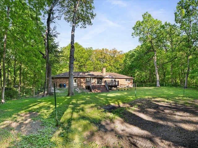 7417 N Hill Rd, Marengo, IL 60152 - view of green lawn featuring a wooden deck and a view of trees
