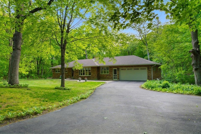 7417 N Hill Rd, Marengo, IL 60152 - ranch-style house featuring a garage, driveway, a front yard, and brick siding