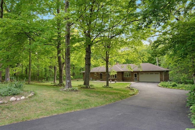 7417 N Hill Rd, Marengo, IL 60152 - view of front of property featuring asphalt driveway, a garage, a chimney, and a front yard