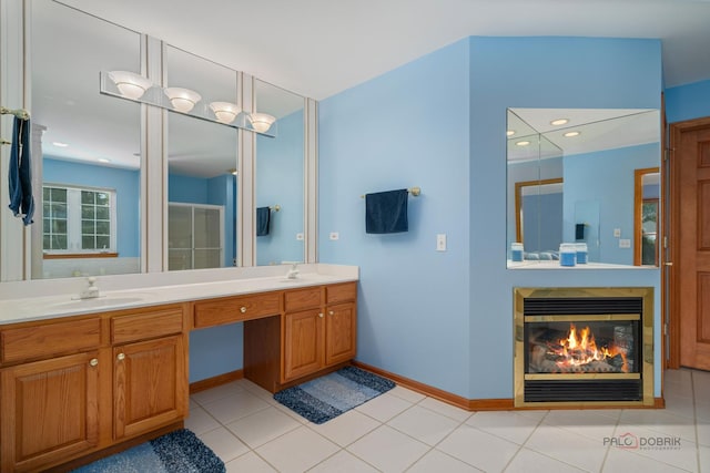 1701 Driftwood Ln, Crystal Lake, IL 60014 - full bathroom featuring double vanity, a glass covered fireplace, baseboards, and tile patterned floors