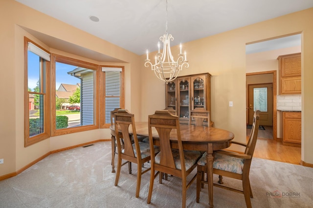 1701 Driftwood Ln, Crystal Lake, IL 60014 - dining space featuring light carpet, a chandelier, and baseboards