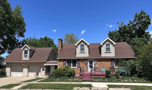 616 E Center St, Ottawa, IL 61350 - cape cod home with a chimney, a garage, driveway, and brick siding