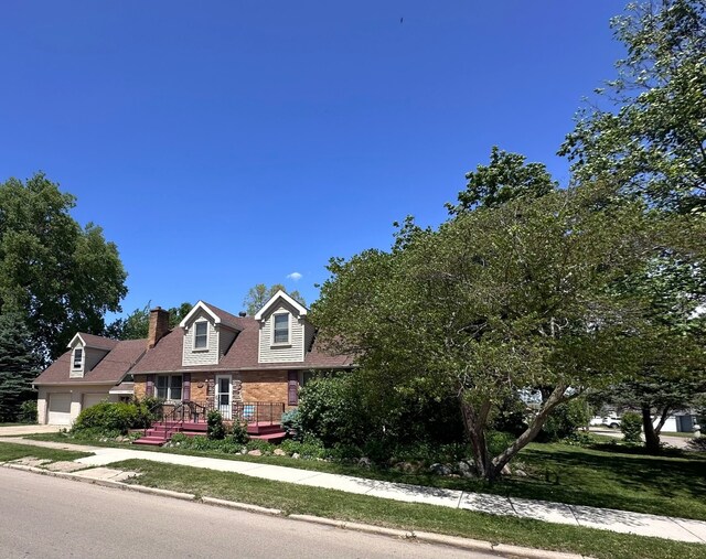 616 E Center St, Ottawa, IL 61350 - view of front of property featuring a wooden deck, a chimney, concrete driveway, and brick siding