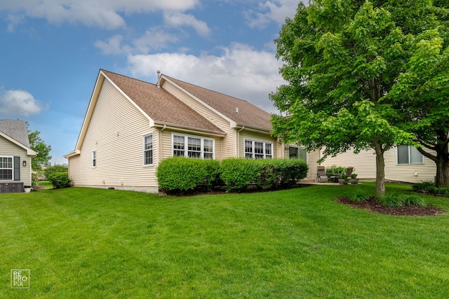 13460 S Magnolia Dr, Plainfield, IL 60544 - view of front facade with a front yard, a shingled roof, and central air condition unit