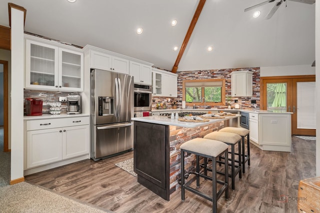4308 Miller Oaks Dr, Mchenry, IL 60051 - kitchen featuring stainless steel refrigerator with ice dispenser, light countertops, white cabinets, a kitchen island, and a breakfast bar area