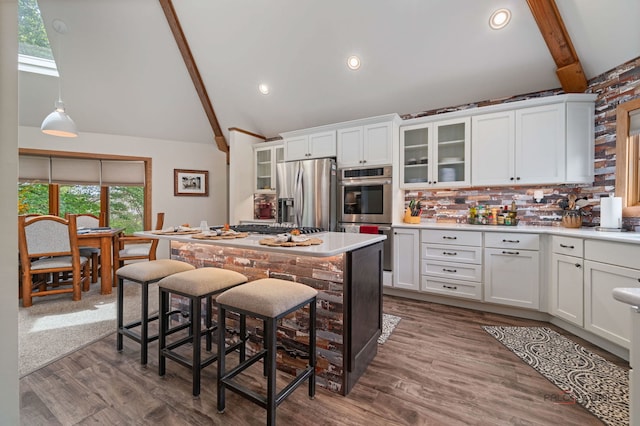4308 Miller Oaks Dr, Mchenry, IL 60051 - kitchen featuring stainless steel appliances, high vaulted ceiling, beam ceiling, white cabinetry, and tasteful backsplash