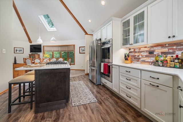 4308 Miller Oaks Dr, Mchenry, IL 60051 - kitchen with appliances with stainless steel finishes, a skylight, a center island, light countertops, and white cabinets