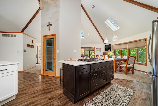 4308 Miller Oaks Dr, Mchenry, IL 60051 - kitchen with high vaulted ceiling, a skylight, stainless steel appliances, baseboards, and light countertops