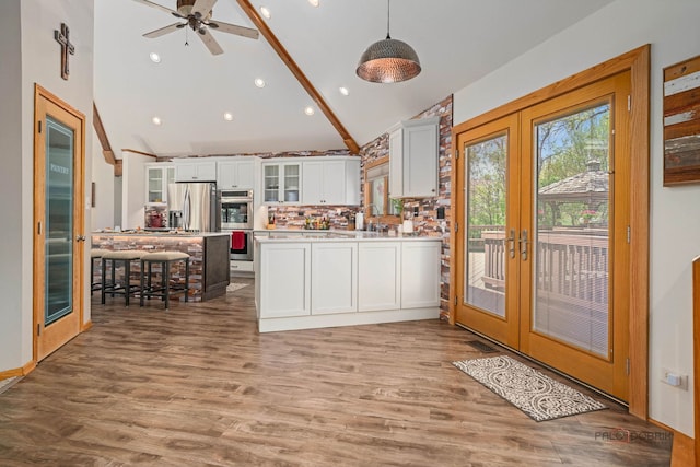 4308 Miller Oaks Dr, Mchenry, IL 60051 - kitchen with appliances with stainless steel finishes, french doors, white cabinets, a peninsula, and light countertops
