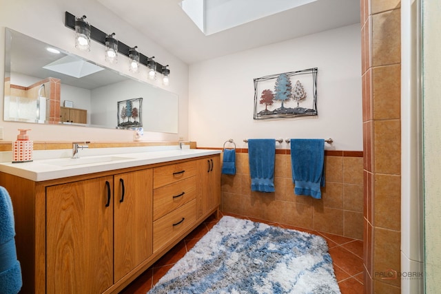 4308 Miller Oaks Dr, Mchenry, IL 60051 - bathroom with tile patterned floors, double vanity, tile walls, a skylight, and wainscoting