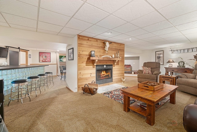 4308 Miller Oaks Dr, Mchenry, IL 60051 - living area with a paneled ceiling, carpet, a fireplace, a bar, and wood walls