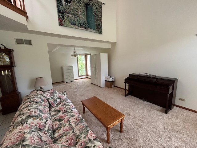 122 San Carlos Rd, Minooka, IL 60447 - living room featuring light carpet, a towering ceiling, and baseboards