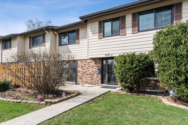 7330 Winthrop Way Unit 2, Downers Grove, IL 60515 - view of front facade with brick siding and a front yard