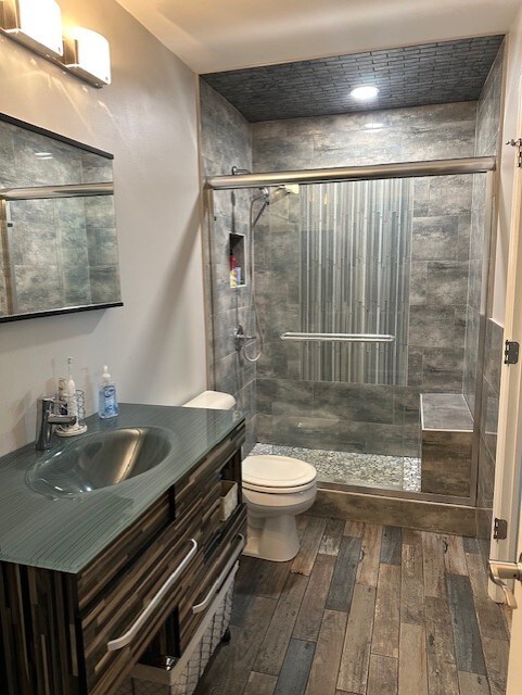 5117 Lear St, Wonder Lake, IL 60097 - full bathroom with toilet, a shower stall, vanity, and wood finished floors
