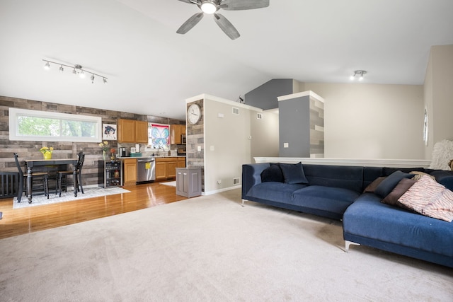 5117 Lear St, Wonder Lake, IL 60097 - living room with lofted ceiling, light colored carpet, a ceiling fan, rail lighting, and light wood-style flooring