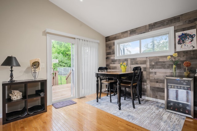 5117 Lear St, Wonder Lake, IL 60097 - dining space featuring vaulted ceiling, wood finished floors, and wooden walls
