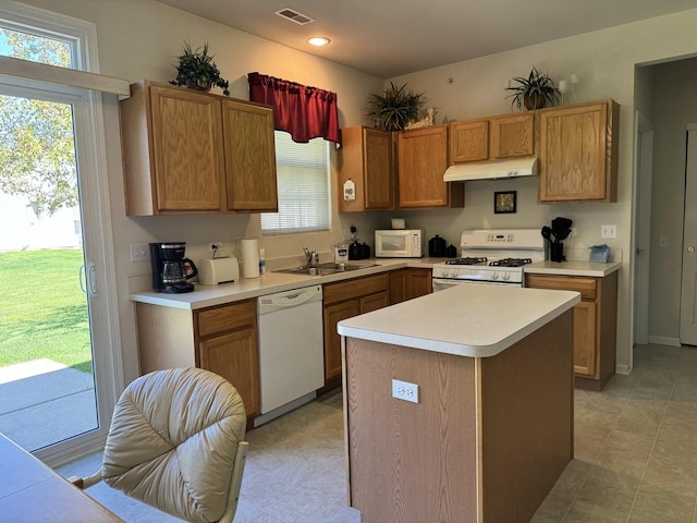 13370 Red Alder Ave, Huntley, IL 60142 - kitchen featuring white appliances, under cabinet range hood, a sink, light countertops, and a center island