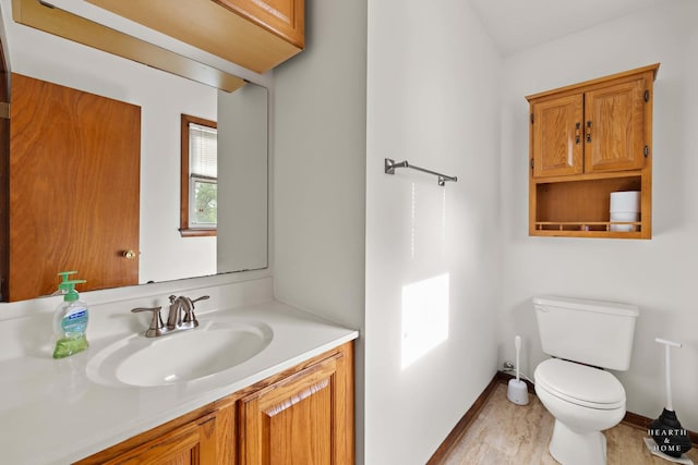 35976 N Fairfield Rd, Ingleside, IL 60041 - half bathroom featuring toilet, baseboards, and vanity