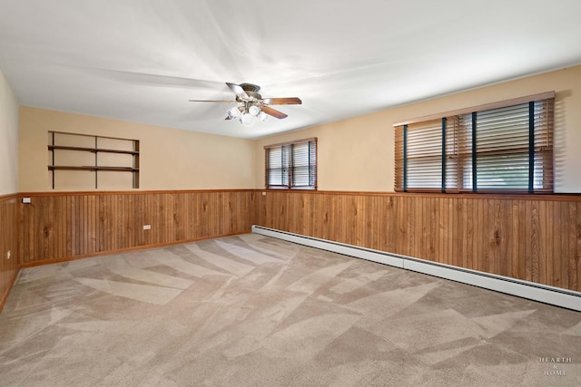 35976 N Fairfield Rd, Ingleside, IL 60041 - spare room with a wainscoted wall, wood walls, carpet, a baseboard radiator, and ceiling fan
