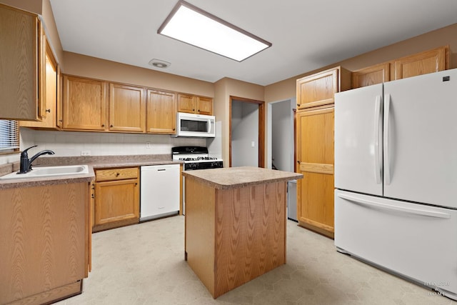 35976 N Fairfield Rd, Ingleside, IL 60041 - kitchen with white appliances, light floors, a sink, a kitchen island, and light countertops