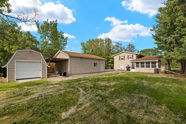 35976 N Fairfield Rd, Ingleside, IL 60041 - rear view of property with a sunroom, a storage unit, an outbuilding, a yard, and a patio