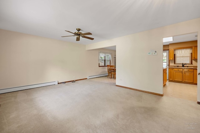 35976 N Fairfield Rd, Ingleside, IL 60041 - unfurnished living room featuring a baseboard radiator, ceiling fan, a sink, light colored carpet, and baseboards