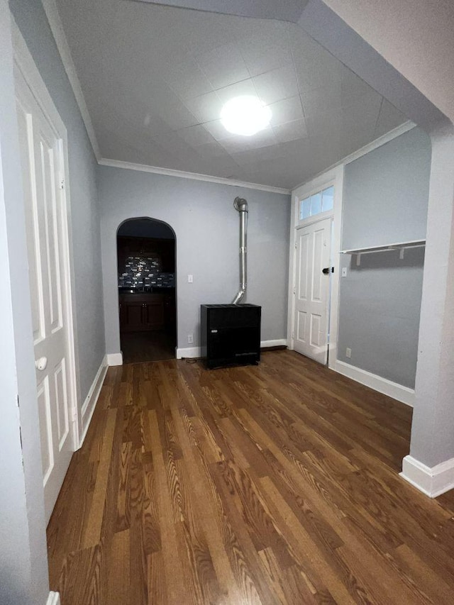 1934 W 21st Pl, Chicago, IL 60608 - unfurnished living room with ornamental molding, wood finished floors, arched walkways, and baseboards