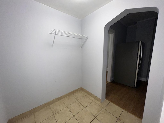 1934 W 21st Pl, Chicago, IL 60608 - walk in closet featuring arched walkways and light tile patterned floors