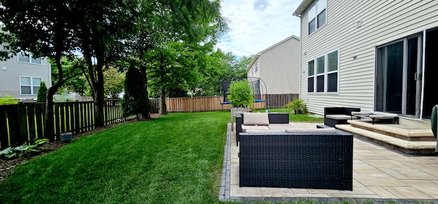2383 Shiloh Dr, Aurora, IL 60503 - fenced backyard with a trampoline, a patio area, and outdoor lounge area