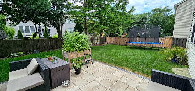 2383 Shiloh Dr, Aurora, IL 60503 - fenced backyard featuring a trampoline and a patio area