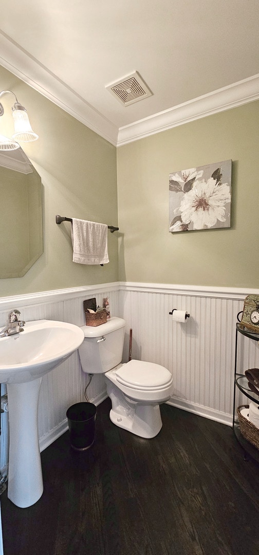 2383 Shiloh Dr, Aurora, IL 60503 - half bath featuring wood finished floors, crown molding, and wainscoting