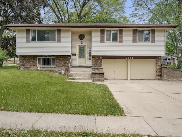 1334 Somerset Ln, Schaumburg, IL 60193 - raised ranch featuring an attached garage, concrete driveway, a front lawn, and brick siding