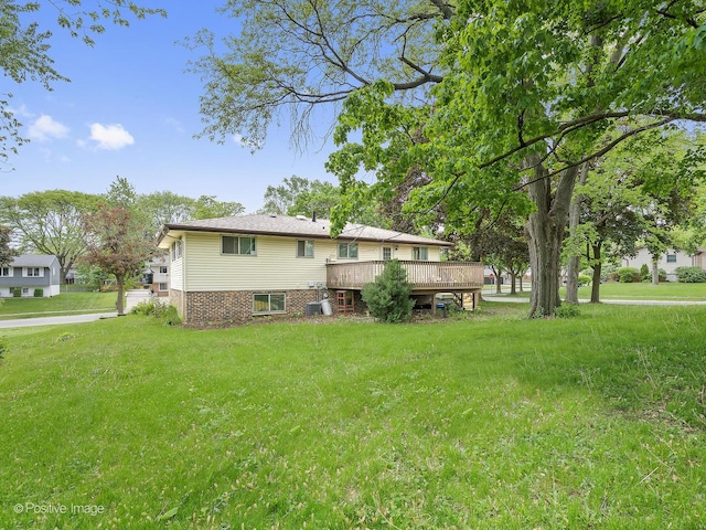 1334 Somerset Ln, Schaumburg, IL 60193 - back of house featuring a deck and a lawn