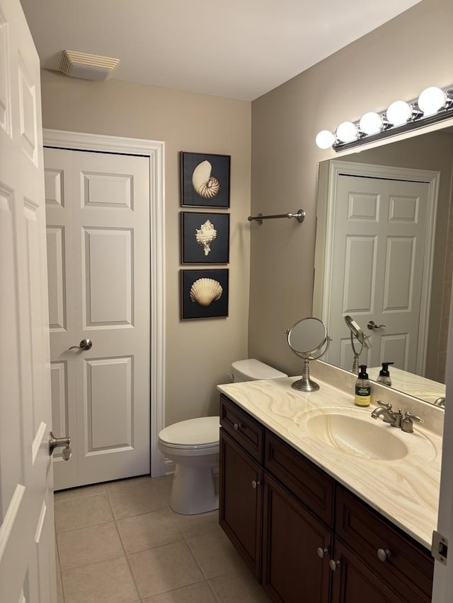 bathroom with tile patterned floors, vanity, and toilet