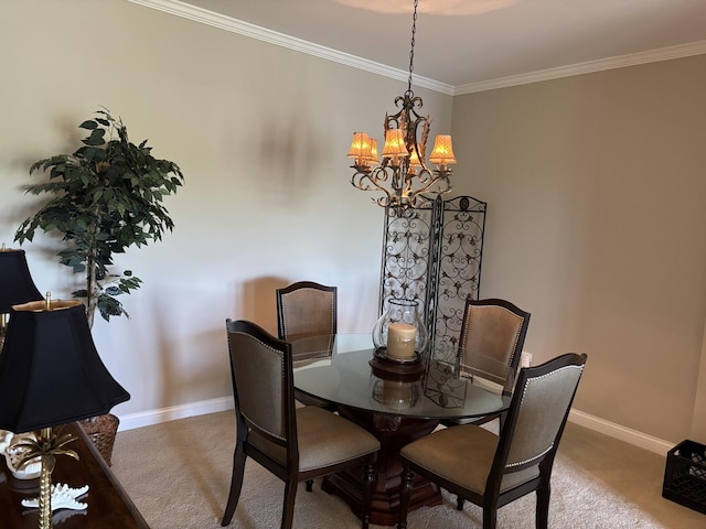 carpeted dining space featuring a chandelier, baseboards, and ornamental molding