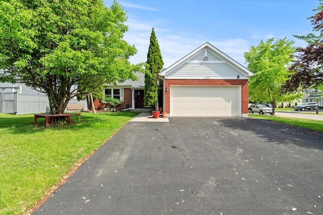 view of front facade with driveway, brick siding, a garage, and a front yard