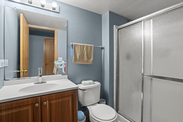 full bath featuring a shower stall, toilet, and vanity
