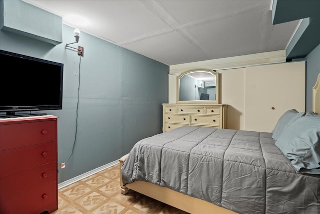 bedroom with light flooring, baseboards, and a closet