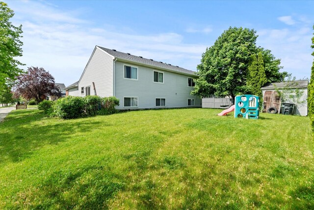 rear view of property with a yard