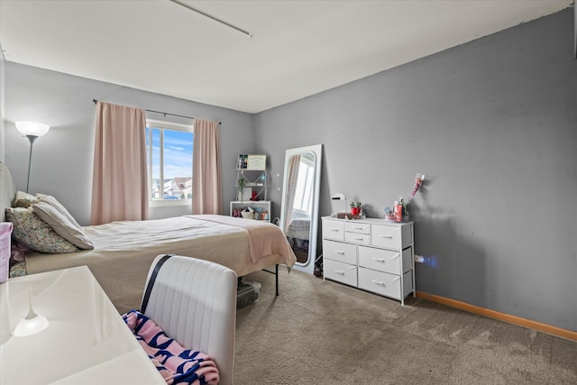 bedroom with carpet floors and baseboards