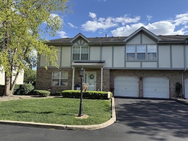 18233 Eagle Dr, Tinley Park, IL 60477 - english style home featuring driveway, a front yard, a garage, stucco siding, and brick siding