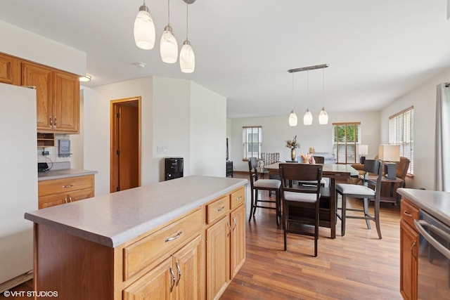 1847 Lake Shore Dr, Romeoville, IL 60446 - kitchen featuring freestanding refrigerator, light wood finished floors, pendant lighting, and dishwasher