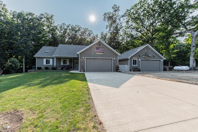 21 Carribean Dr, Putnam, IL 61560 - ranch-style home with a front yard, concrete driveway, a garage, and an outdoor structure