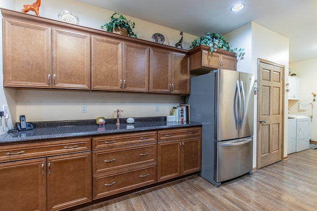 21 Carribean Dr, Putnam, IL 61560 - kitchen with freestanding refrigerator, washer and clothes dryer, light wood-style floors, dark stone counters, and recessed lighting
