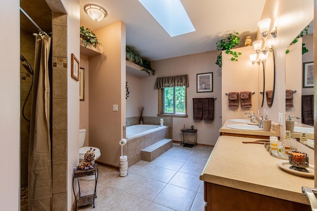 21 Carribean Dr, Putnam, IL 61560 - full bathroom featuring a bath, a skylight, tile patterned floors, toilet, and double vanity
