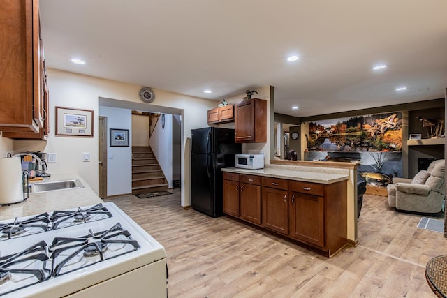 21 Carribean Dr, Putnam, IL 61560 - kitchen with white appliances, a sink, light wood-style flooring, light countertops, and recessed lighting