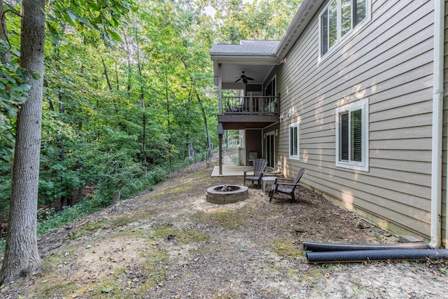 21 Carribean Dr, Putnam, IL 61560 - view of yard featuring a fire pit, a balcony, and a ceiling fan